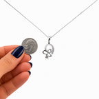 10K white gold 0.73 carat natural diamond butterfly pendant necklace with US dime for size comparison.