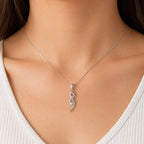 Model wearing a 10K white gold pendant necklace featuring a 0.60 carat natural round diamond on an 18-inch box chain, elegant minimalist fine jewelry.