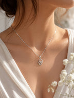 Close-up of a model wearing a 10K white gold butterfly pendant necklace featuring 0.73 carat natural diamonds on a fine box chain, elegant everyday fine jewelry.