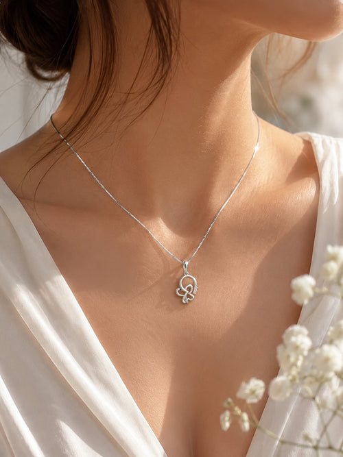 Close-up of a model wearing a 10K white gold butterfly pendant necklace featuring 0.73 carat natural diamonds on a fine box chain, elegant everyday fine jewelry.