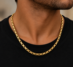 Men's 14K yellow gold rectangular link chain necklace worn with a black shirt, featuring polished gold links and a modern luxury design by La Noosha Jewelry