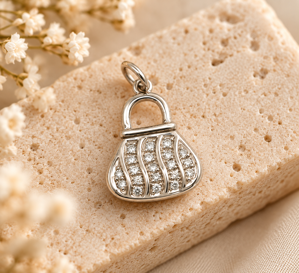 14K white gold handbag charm pendant featuring sparkling stones and elegant purse-shaped detailing on a white background.