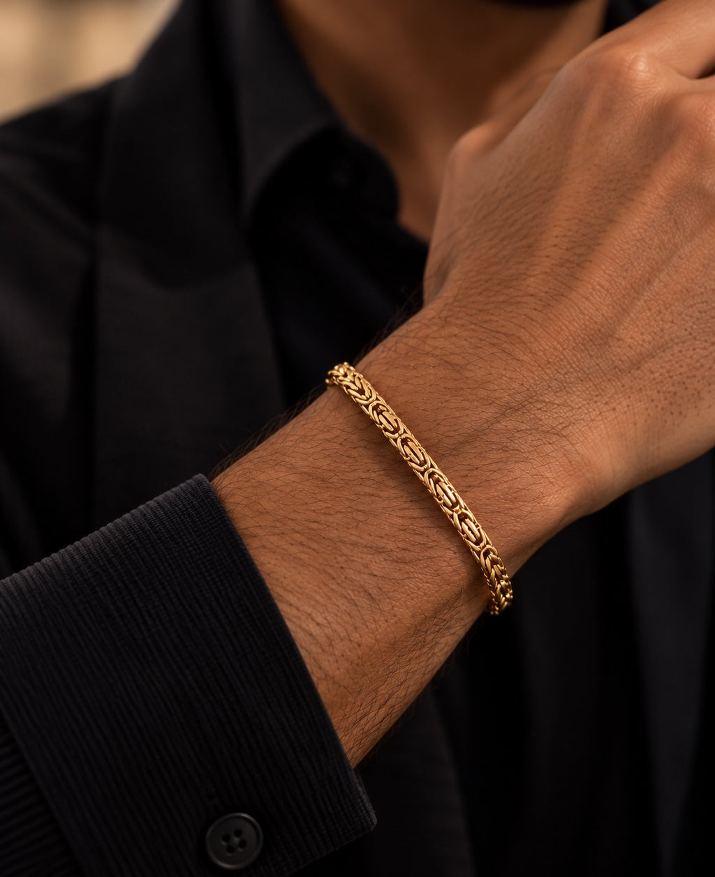 14K yellow gold men's Byzantine chain bracelet featuring intricate interwoven links, worn on a man's wrist with a black shirt.