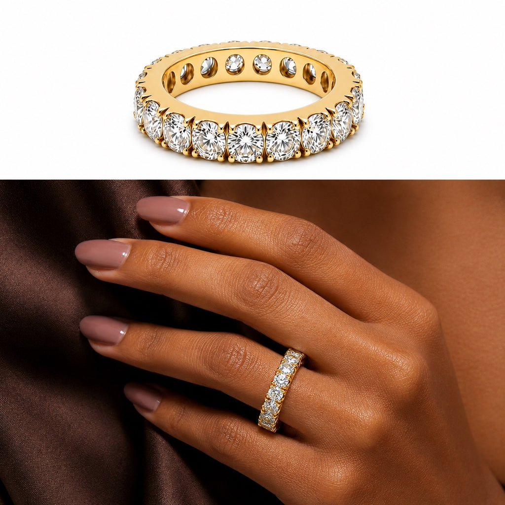 18K yellow gold eternity band featuring 3.75 carats total weight of round brilliant diamonds, shown in a studio product image and elegantly worn on a woman’s finger.