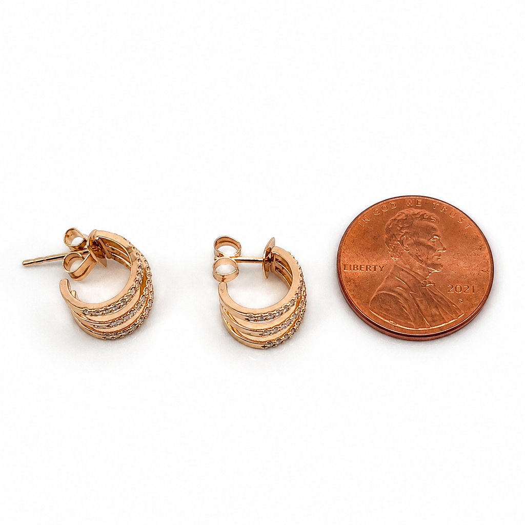 18K gold diamond triple row hoop earrings shown beside a US penny for size reference