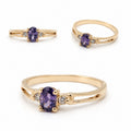 Elegant 14K gold ring featuring an oval-cut amethyst center stone with sparkling diamond accents