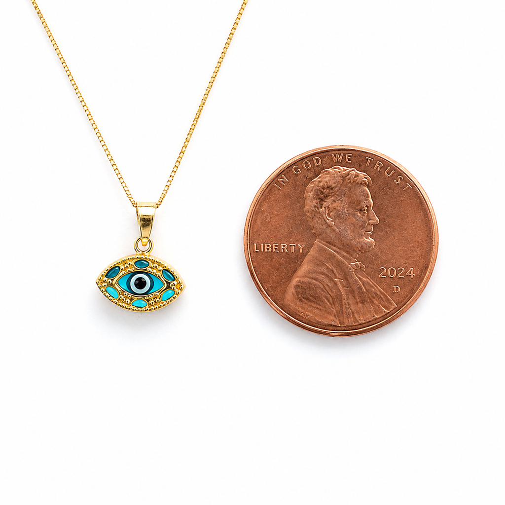 14K gold evil eye pendant necklace shown beside a US penny for size reference.
