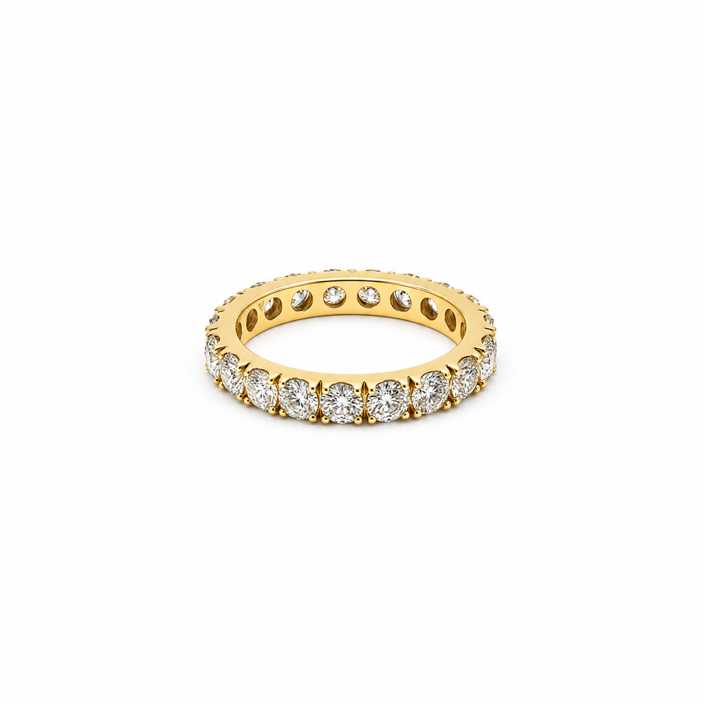 18K yellow gold eternity band featuring 3.75 carats total weight of round brilliant diamonds in a shared-prong setting.