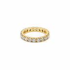 18K yellow gold eternity band featuring 3.75 carats total weight of round brilliant diamonds in a shared-prong setting.