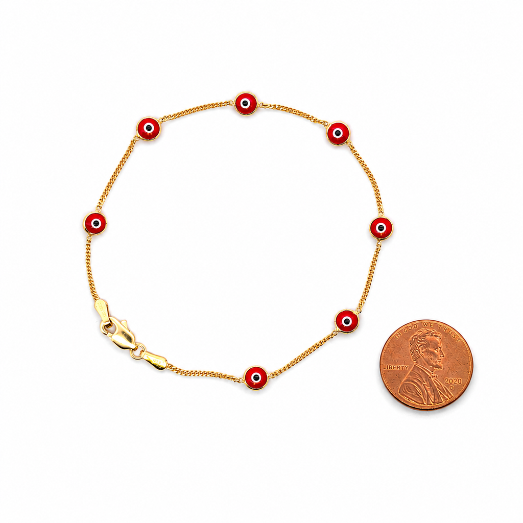 14K yellow gold red evil eye bracelet with enamel charms shown next to a coin for size comparison, delicate luxury everyday jewelry