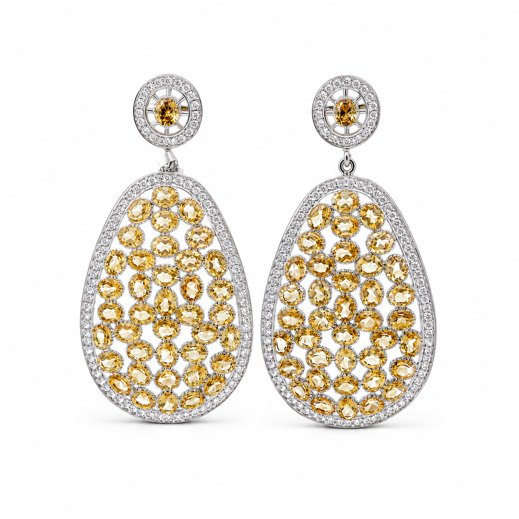 Sterling silver teardrop earrings featuring champagne citrine-colored gemstones and sparkling cubic zirconia accents in an elegant openwork design.