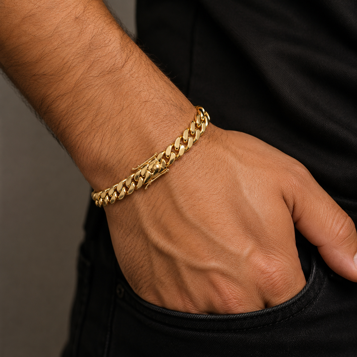 18K gold Miami Cuban link bracelet on men's wrist featuring polished links and a secure box clasp