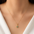 Model wearing a 14K gold Star of David evil eye necklace with blue enamel detailing