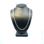 14K yellow gold diamond tennis necklace worn on mannequin with bezel set stones