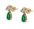 Luxury 18K gold emerald and diamond drop earrings shown from side angle with elegant drop design