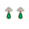 Natural emerald and diamond drop earrings in 18K gold on white background