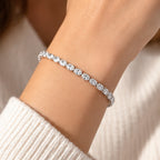 Delicate East-West oval diamond tennis bracelet with sparkling horizontally set stones styled with a cream sweater.