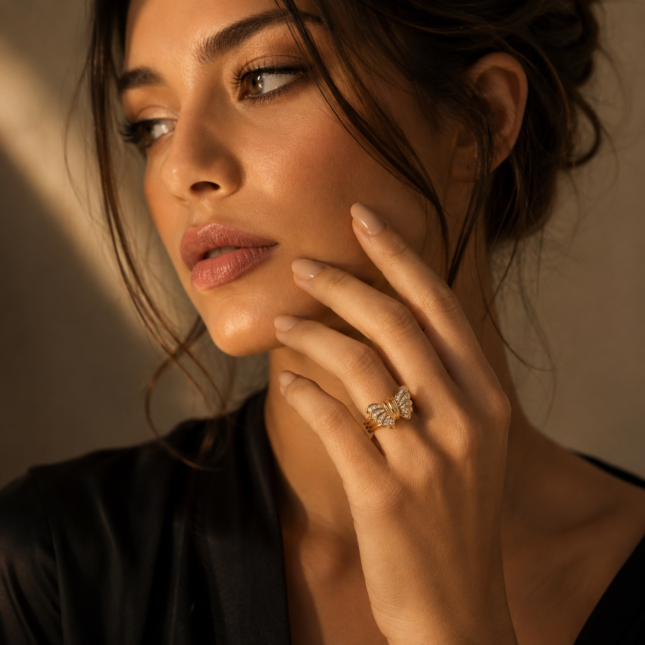 Woman wearing a 14K gold diamond butterfly ring, luxury fine jewelry statement ring