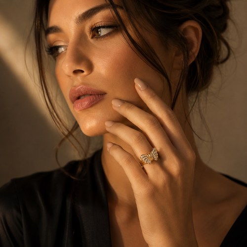 Woman wearing a 14K gold diamond butterfly ring, luxury fine jewelry statement ring
