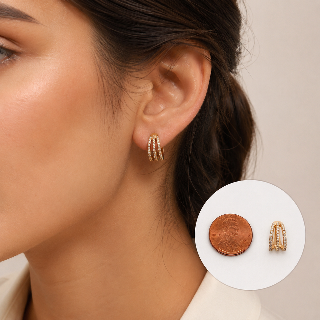 Woman wearing 18K gold diamond triple row hoop earrings featuring pavé diamonds with penny size comparison