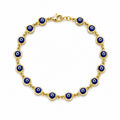 Luxury 14K yellow gold evil eye bracelet for women with blue evil eye details, designer fine jewelry from Los Angeles USA