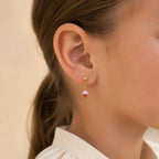Child wearing colorful gold ice cream cone drop earrings