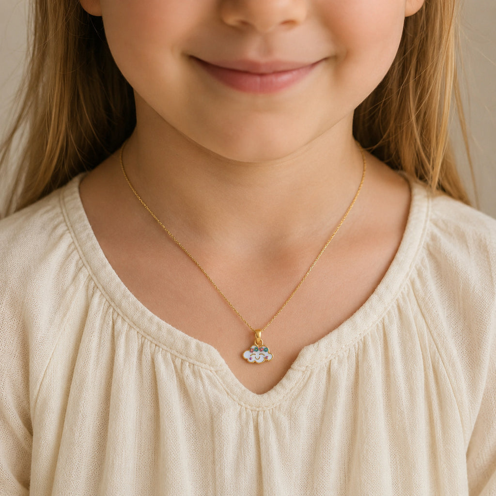 Child wearing a gold smiling cloud pendant with colorful flowers
