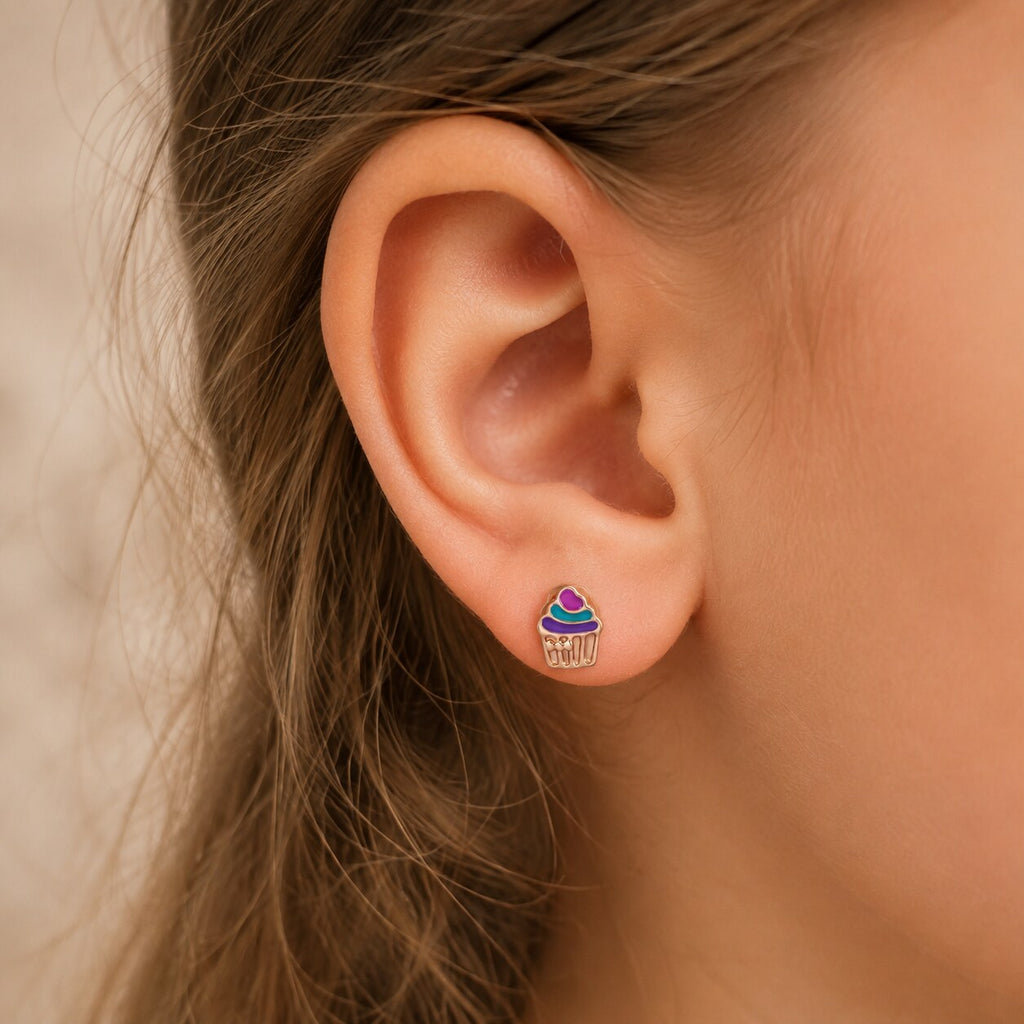 Child wearing a small colorful rose gold cupcake stud earring