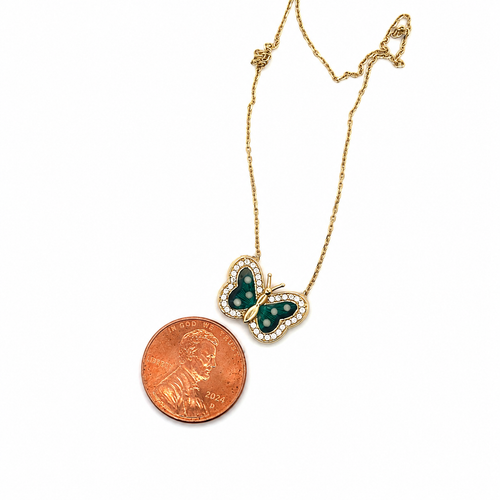 14K gold green enamel butterfly necklace with CZ accents displayed next to a U.S. penny for size comparison